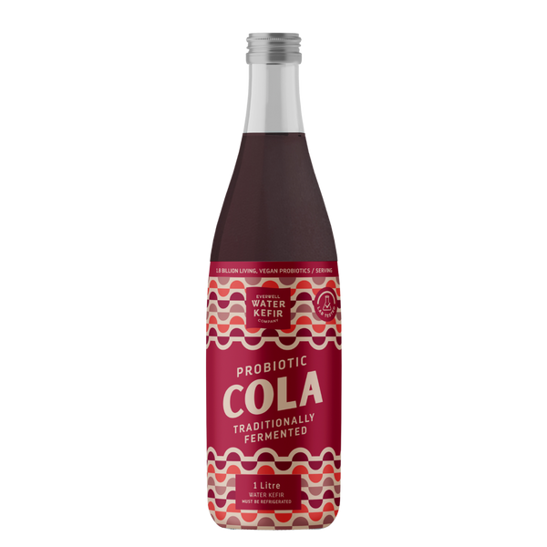 Bottle of probiotic cola with a red label on a white background