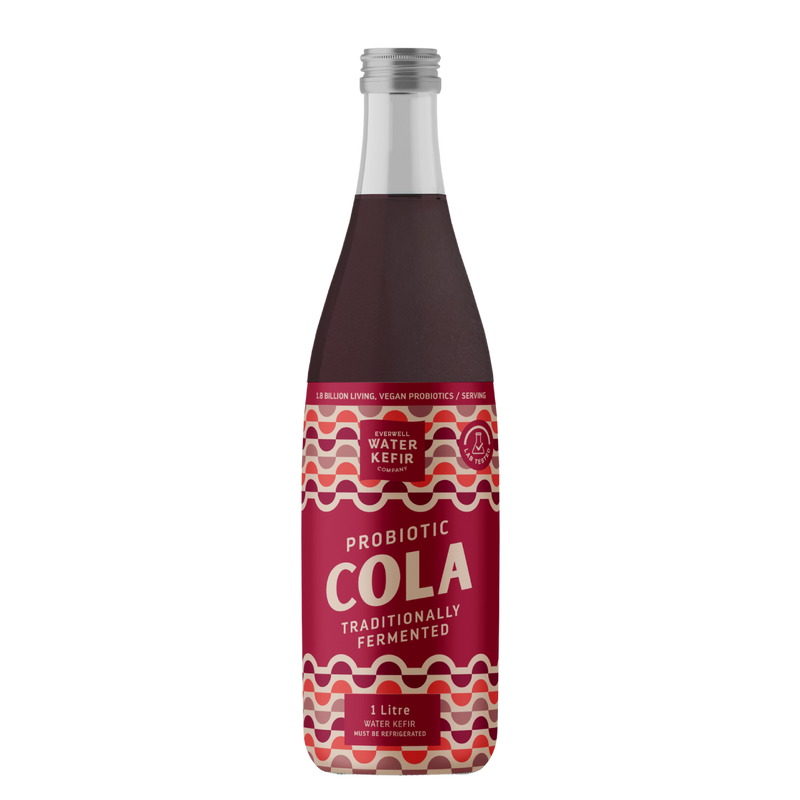 Bottle of probiotic cola with a red label on a white background