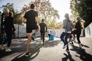 Group of runners participating in an outdoor race on a sunny day - marathon running event