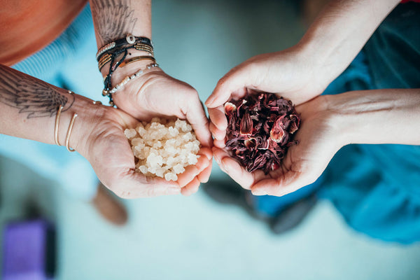 Two hands holding small piles of fresh white and red organic berries